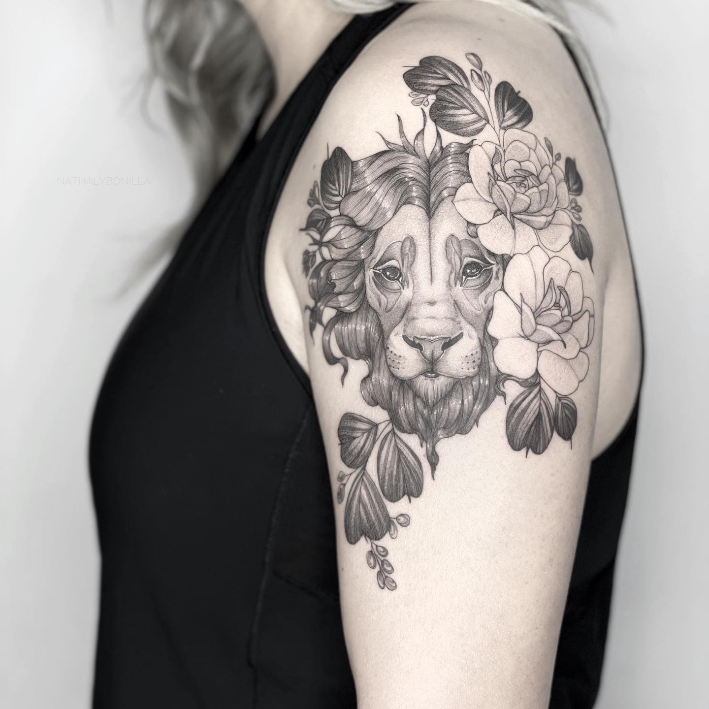 A Majestic Lion Surrounded by Ornate Florals Tattoo