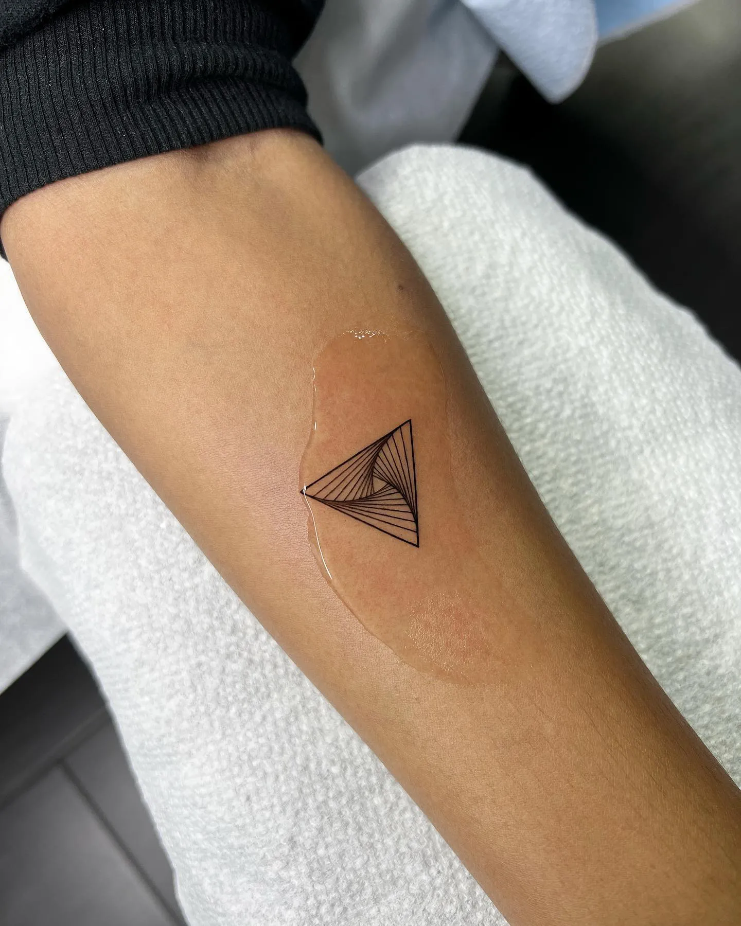 Alluring Negative Space Triangle Tattoo on Forearm
