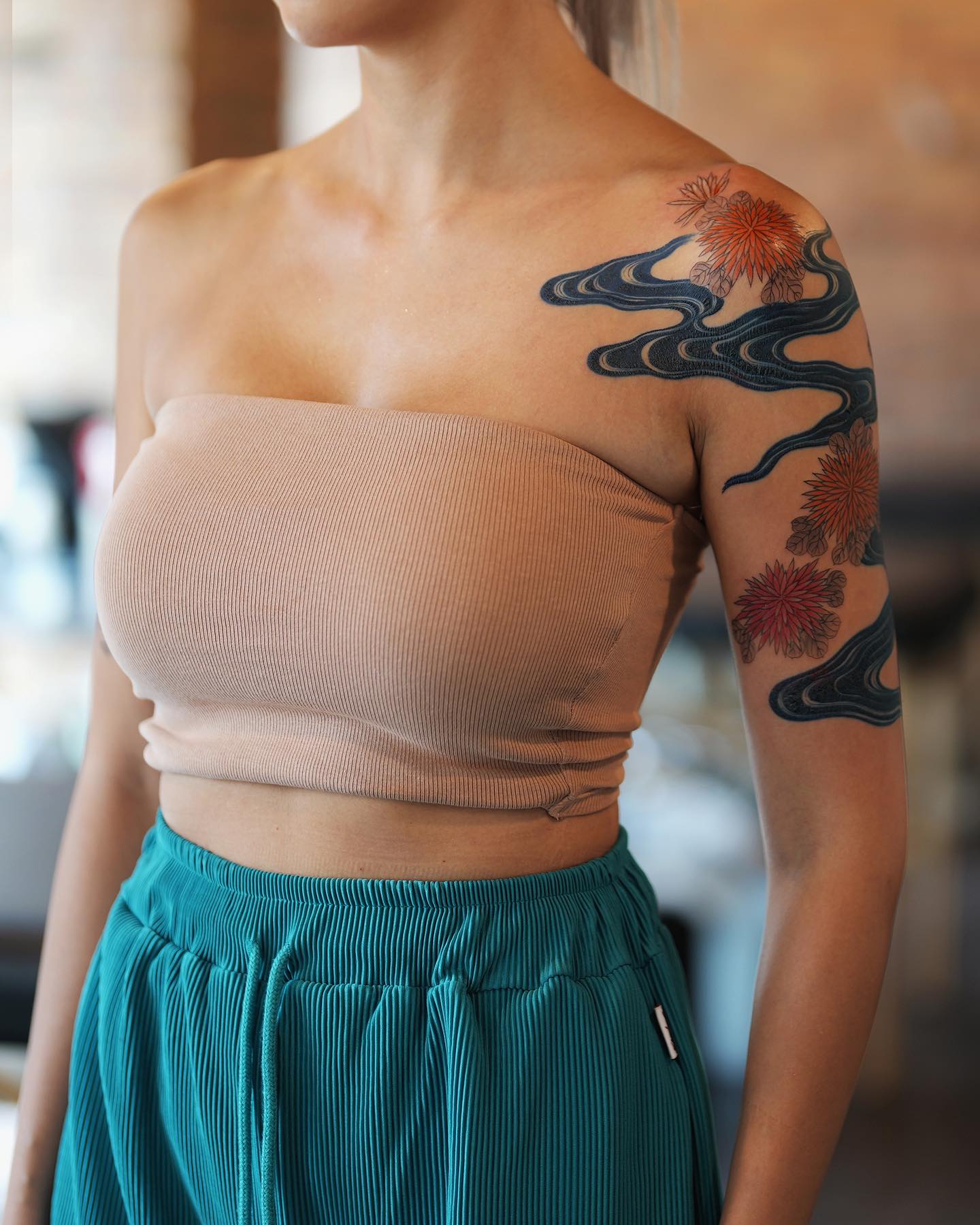 Artistic Floral and Wave Sleeve Tattoo on Arm