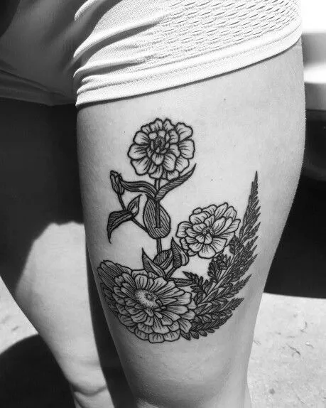 Black ink Zinnia tattoo on thigh simplicity