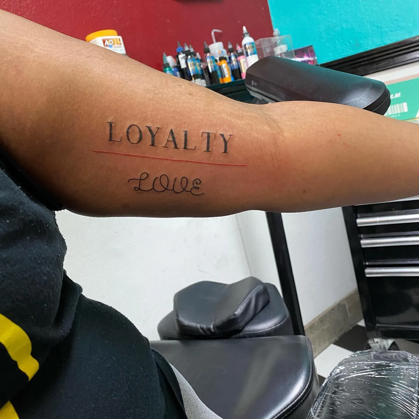 Bold Loyalty Over Love Forearm Render in Capital Letters