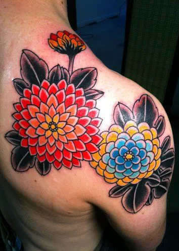 Bold Zinnia tattoo with a burst of colors