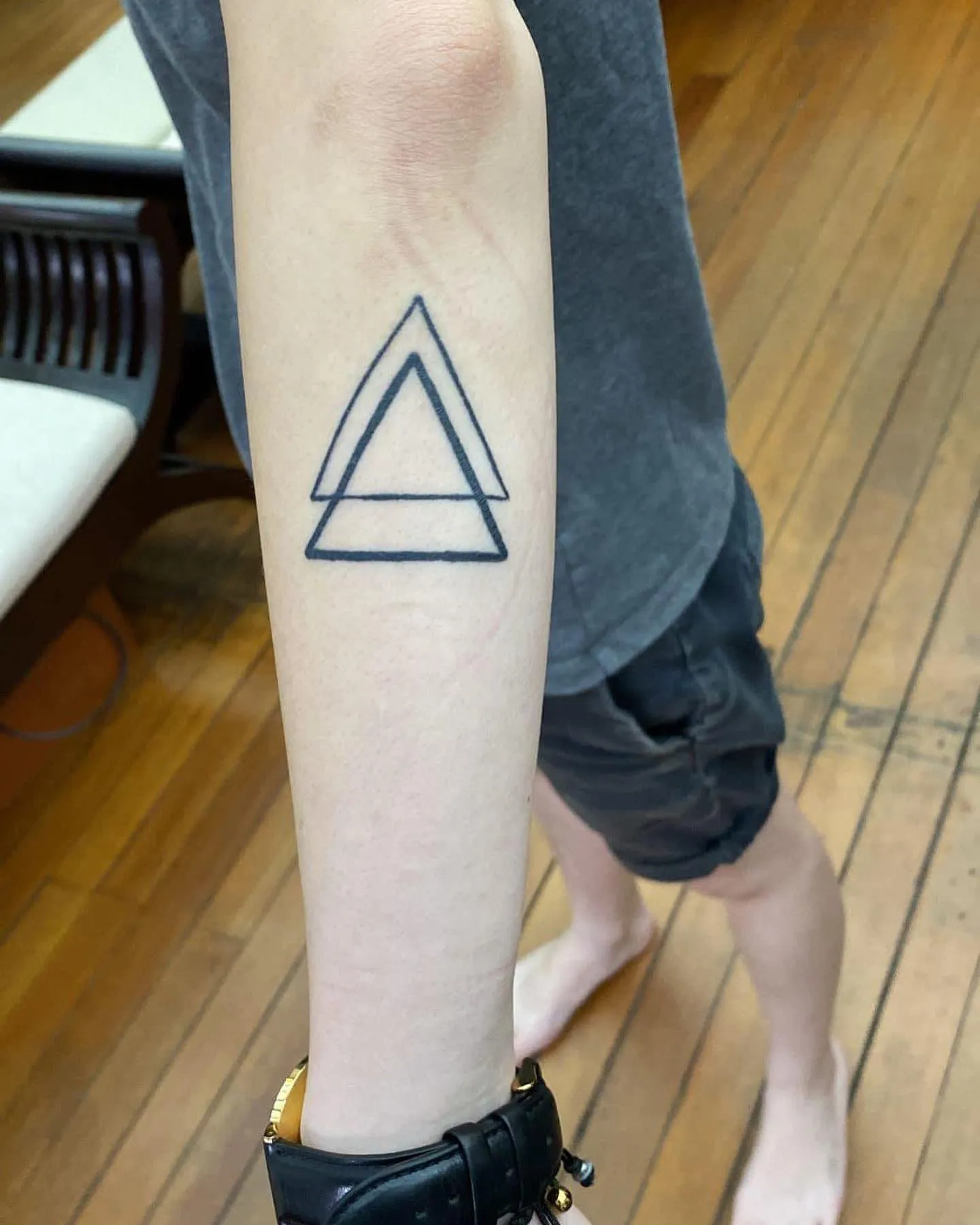 Bold and Defined Double Triangle Tattoo on Arm double triangle tattoo