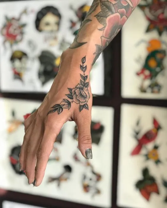 Botanical Chic Rose Tattoo on Side Hand for a Floral Touch