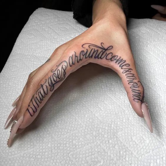 Circular quote tattoo encircling the hand side