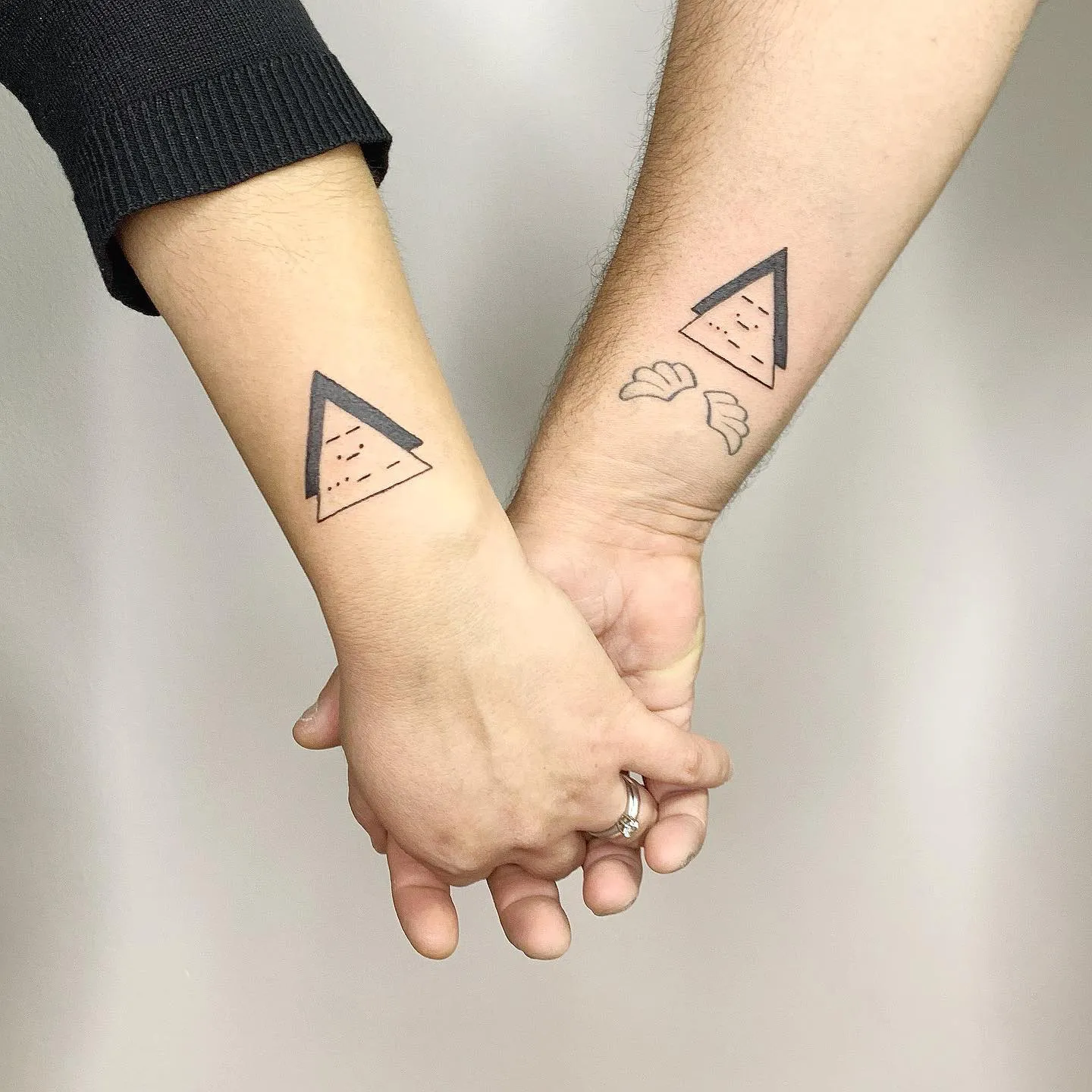 Couple's Matching Triangle Tattoos with Accents