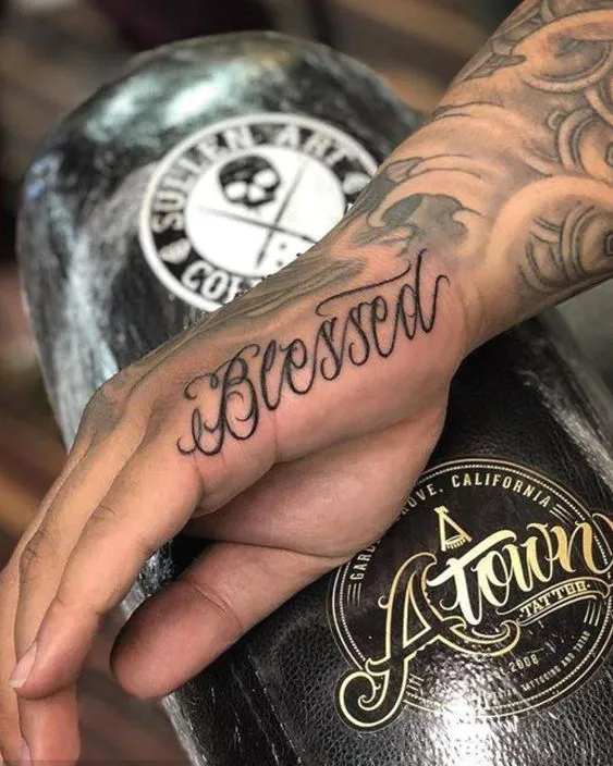 Cursive 'Blessed' for side hand tattoo designs female