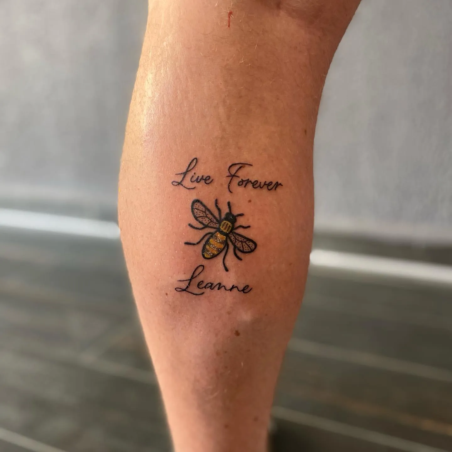 Delicate Bee and Script Tribute Tattoo