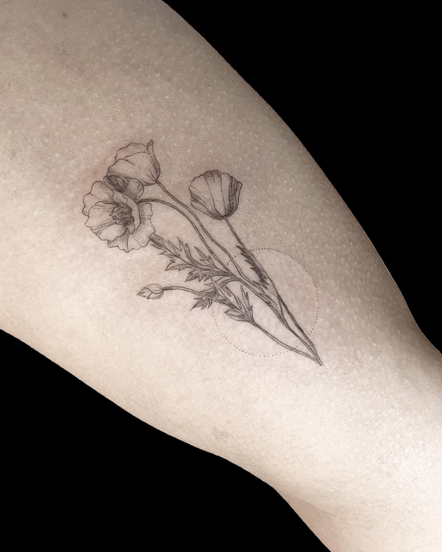 Delicate Black Ink Floral Tattoo on Forearm