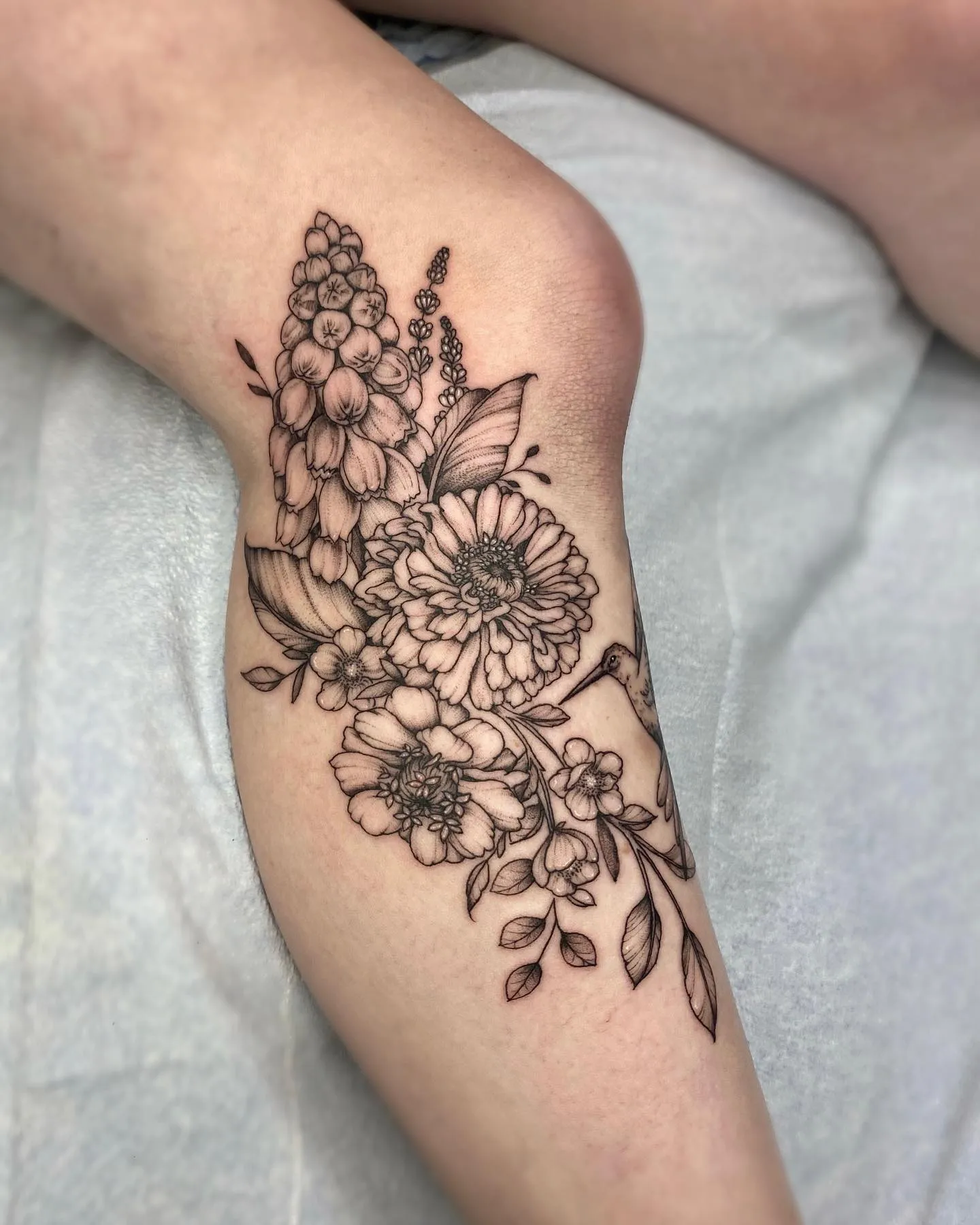Detailed Floral Zinnia Tattoo on Upper Thigh