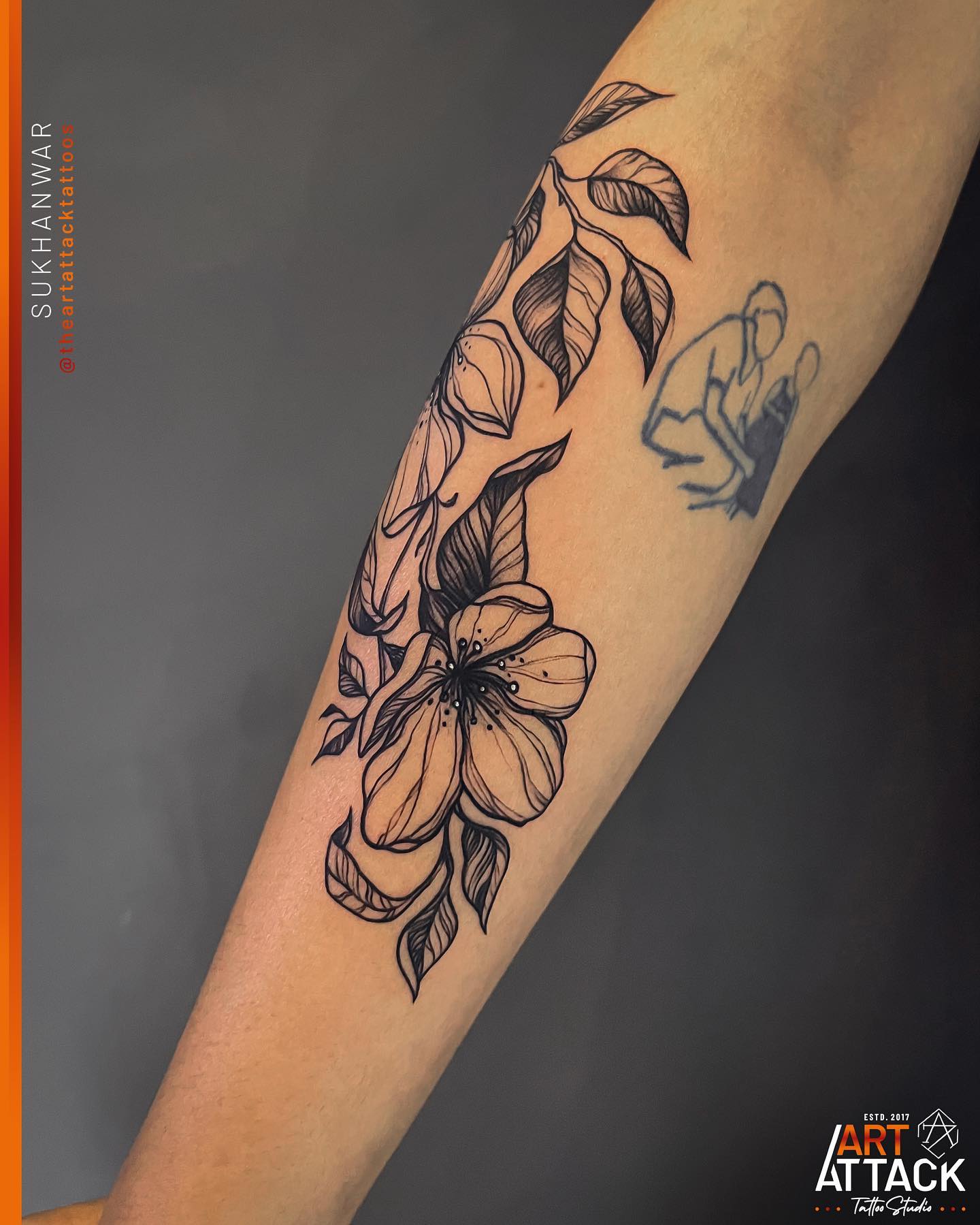 Elegant Black Ink Floral Tattoo on Forearm