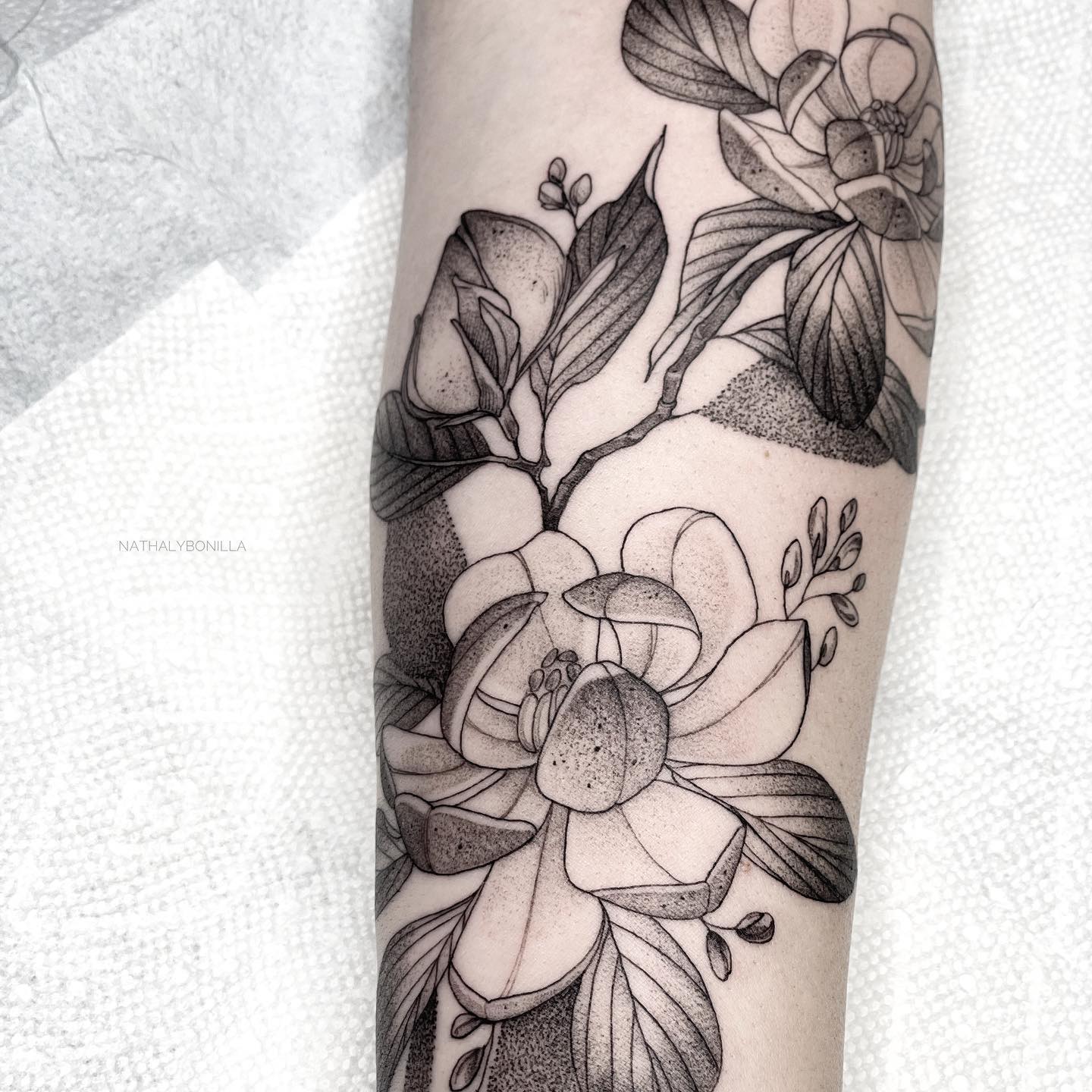 Elegant Black and Grey Floral Tattoo on Arm
