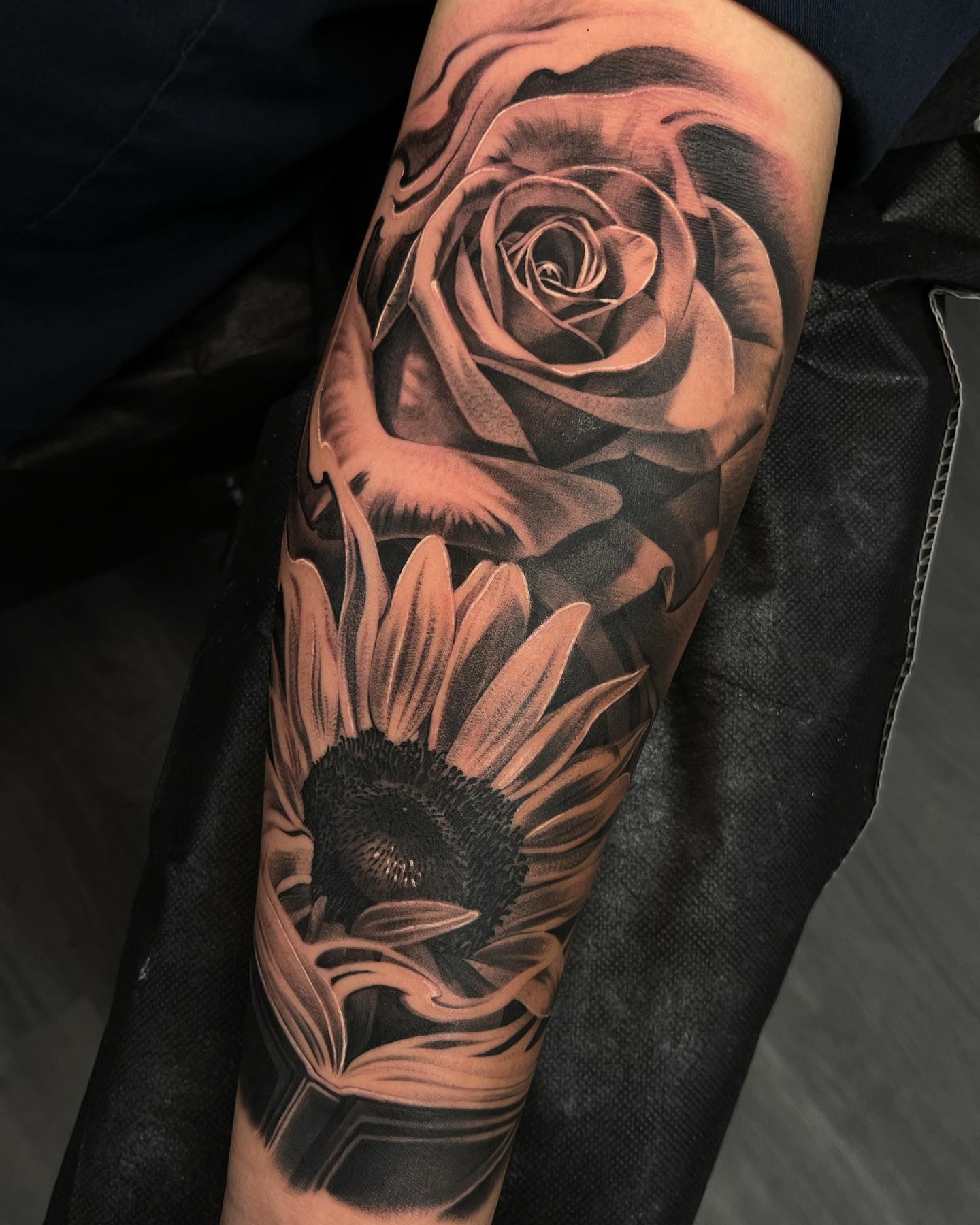 Elegant Black and Grey Floral Tattoo on Forearm