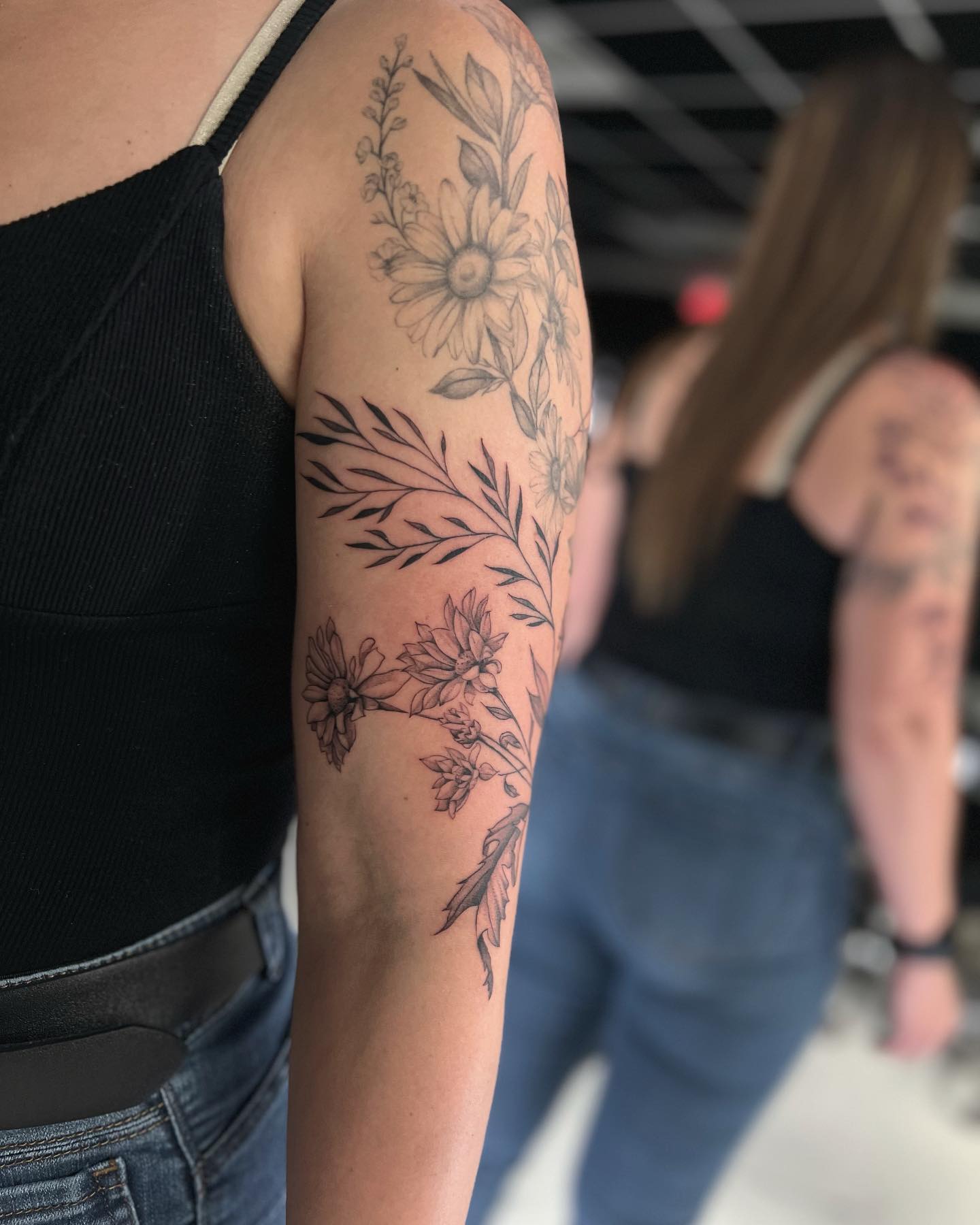 Elegant Floral Tattoo on Upper Arm