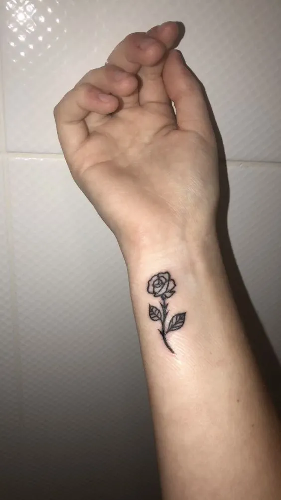 Elegant small rose side hand tattoo for females