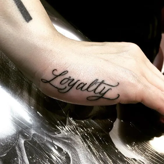 Elegant word 'Loyalty' side hand tattoo ideas