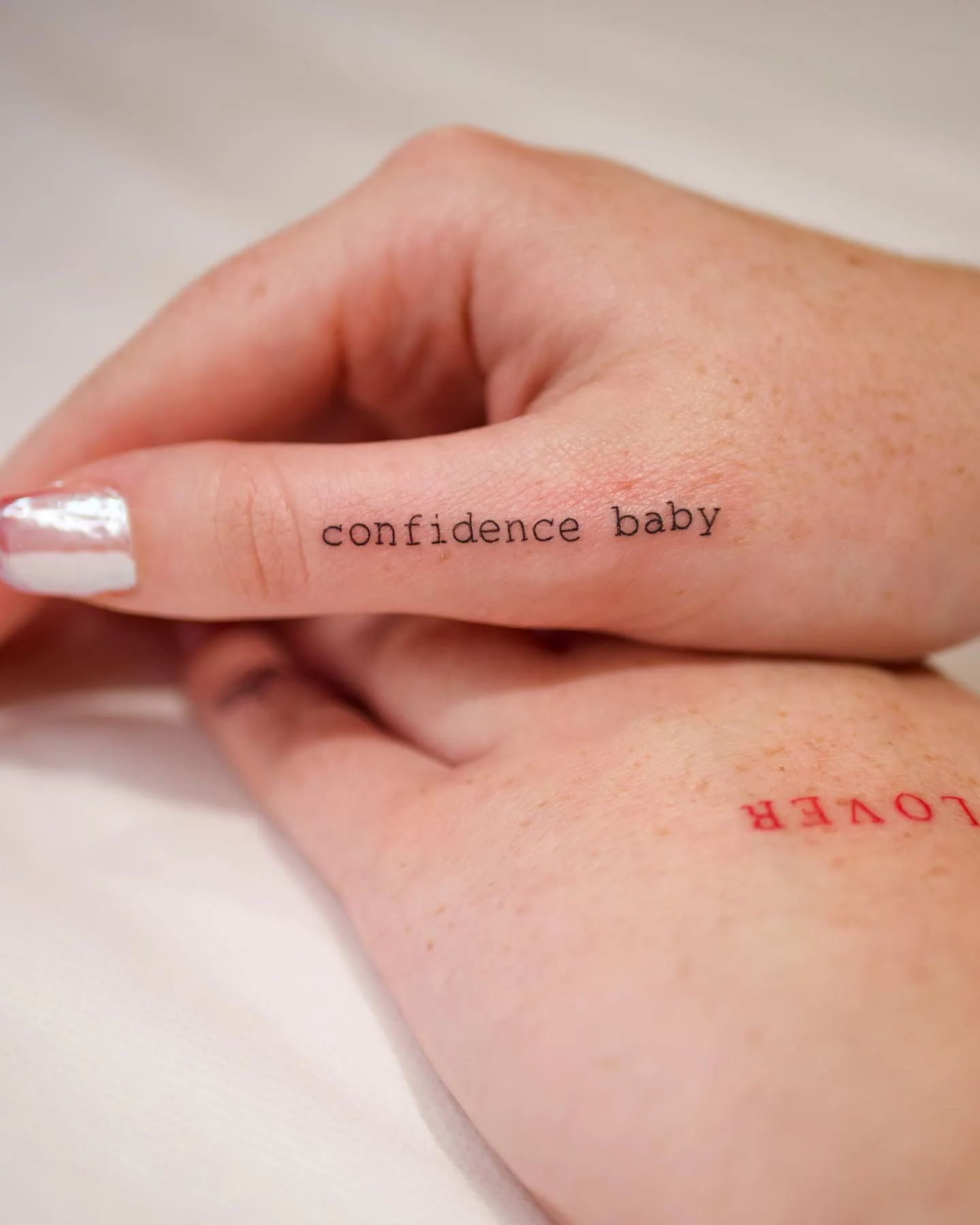 Empowering 'confidence baby' Phrase Tattoo on Hand Side