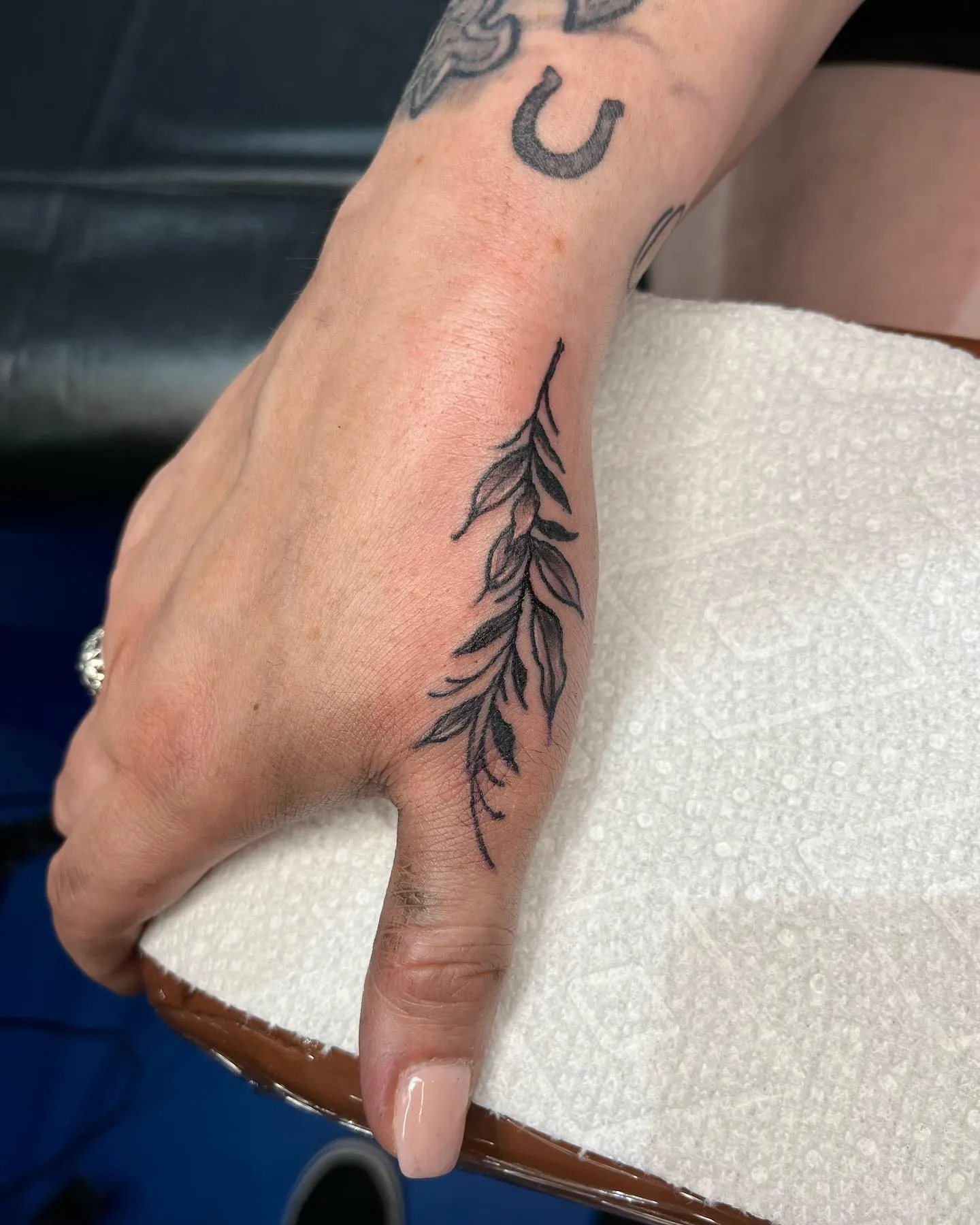 Feathers and Foliage Side Hand Tattoo