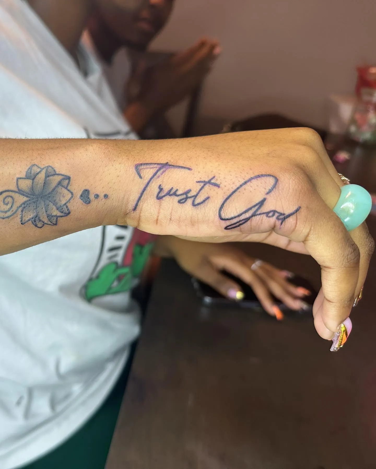 Floral accent side hand tattoo with a message