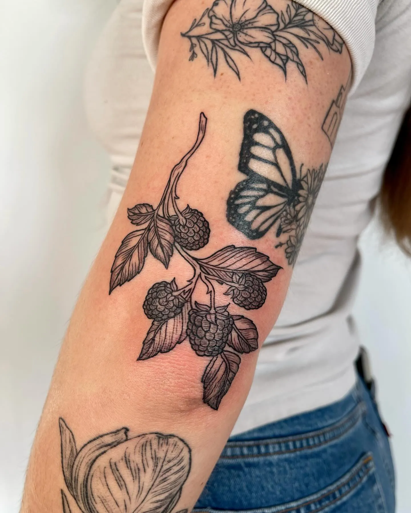 Forearm Blackberry Tattoo with Butterfly Companion