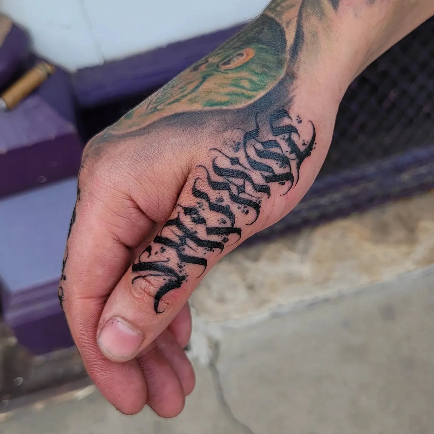 Intricate Script Wrapped on the Side Hand