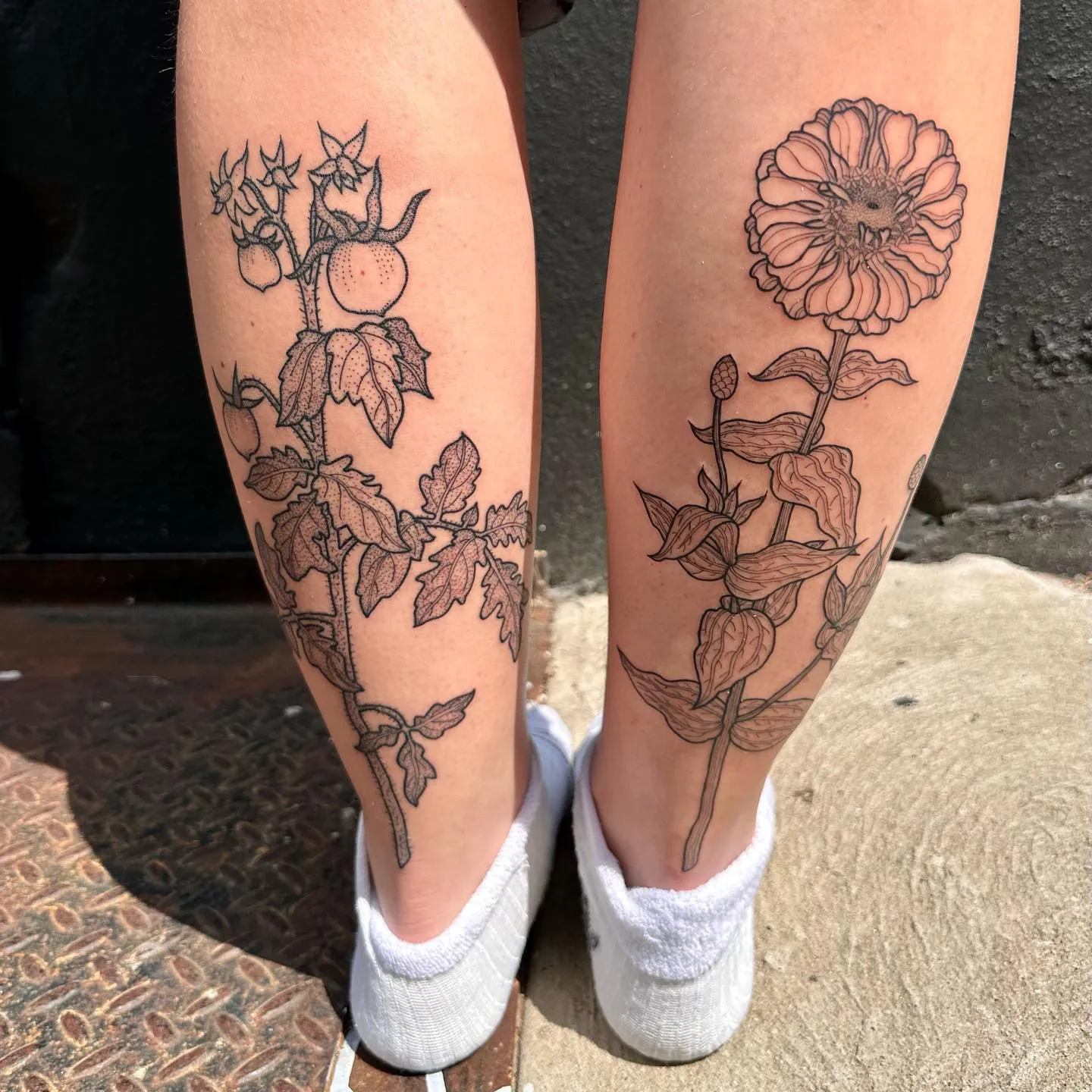 Intricate Zinnia Tattoo Embracing the Legs