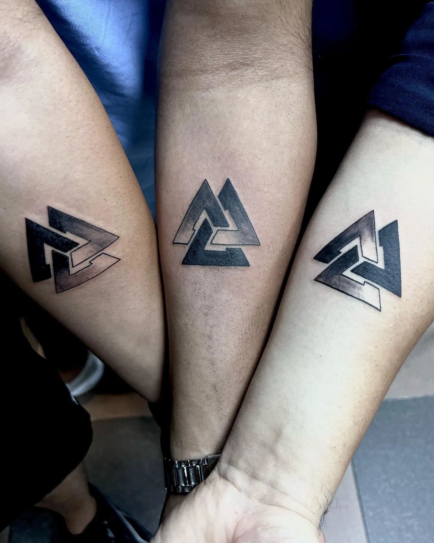Matching Triangular Tattoos Show Unity and Bond