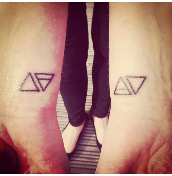 Paired Triangle Tattoos on Feet for Partnership