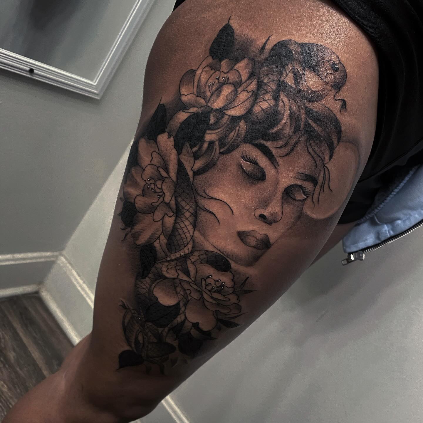 Serene Female Portrait with Floral Accents Tattoo