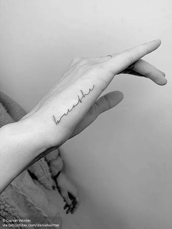 Simple Handwritten Phrase Tattoo on Side of Hand