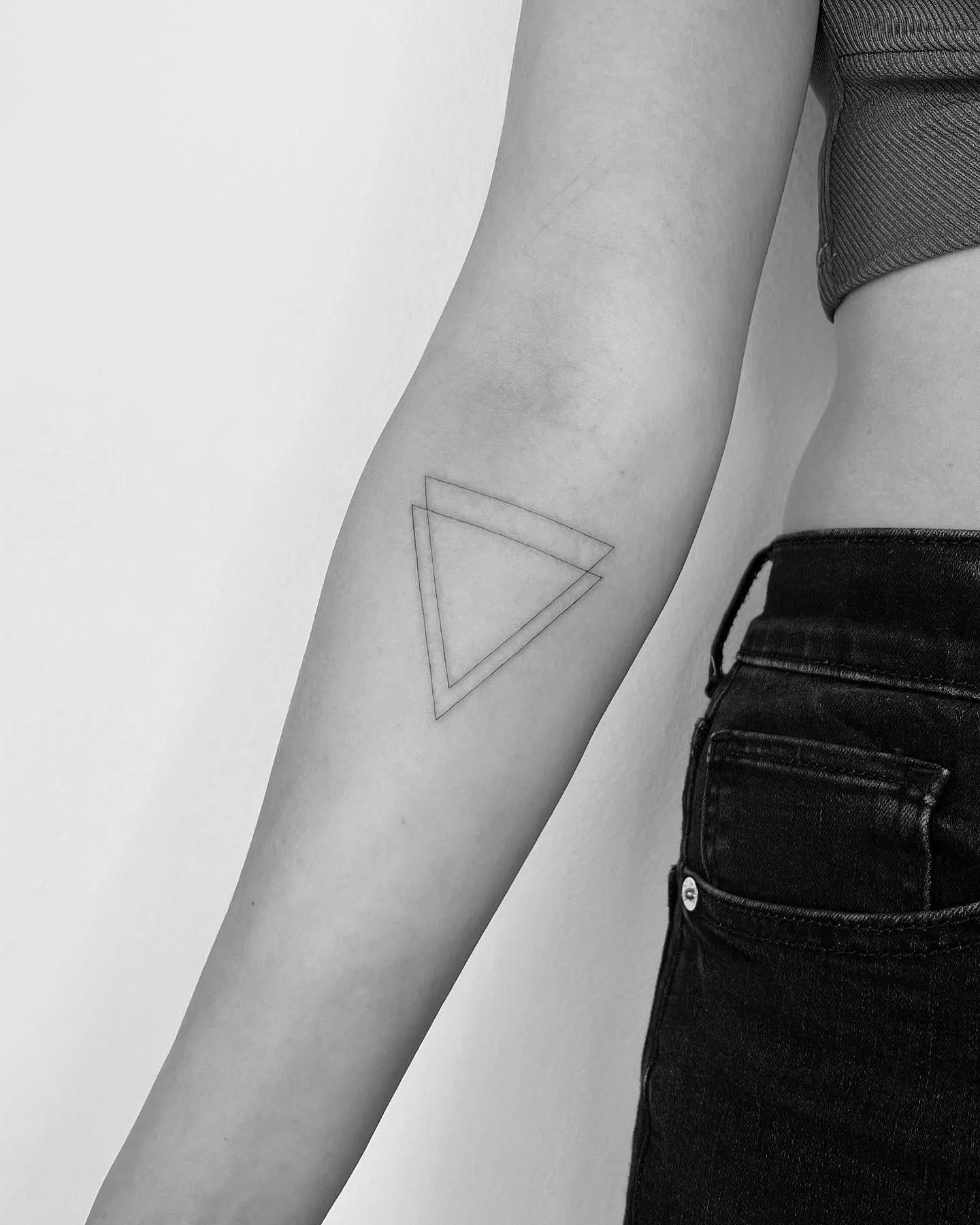 Sleek Double Triangle Tattoo on Forearm