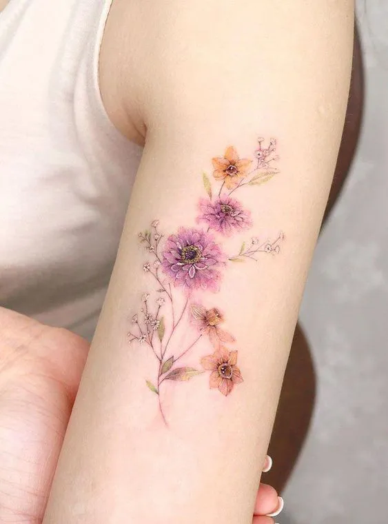 Soft Watercolor Zinnia Tattoo on Upper Arm