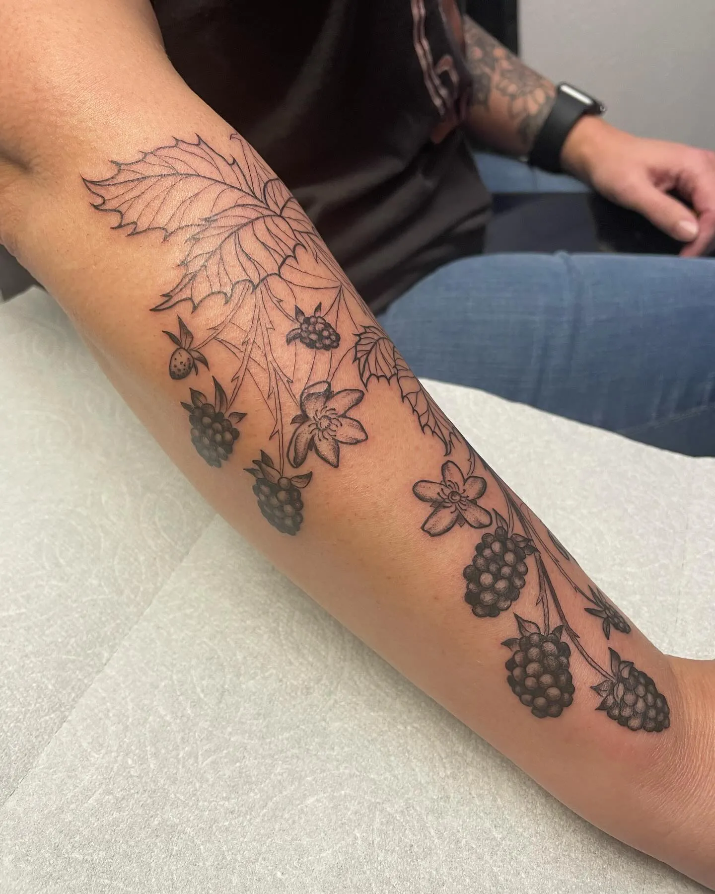 Subtle blackberry tattoo meaning on forearm