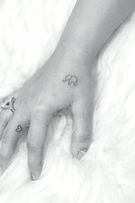 Tiny elephant and heart girly side of hand tattoo designs