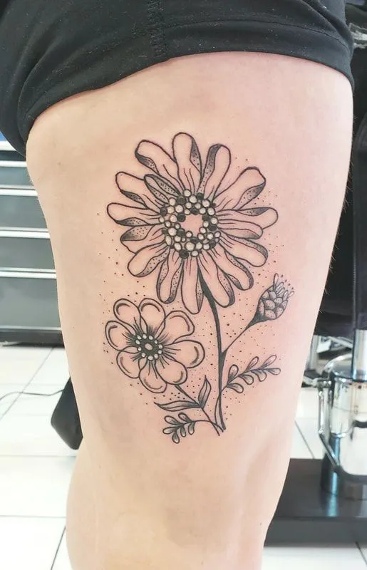 Zinnia tattoo in dotwork style on thigh