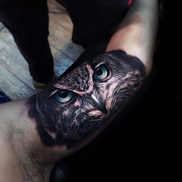 incredible realistic inner arm bicep male owl with blue eyes tattoo Outsons