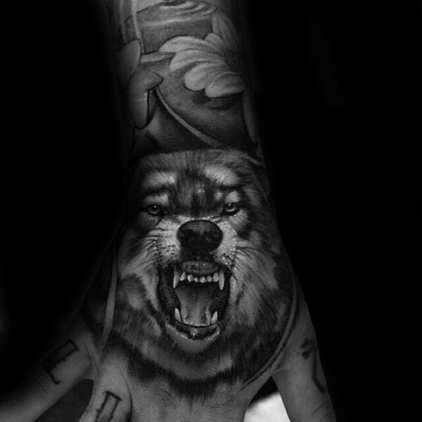 Realistic Wolf Hand Tattoo