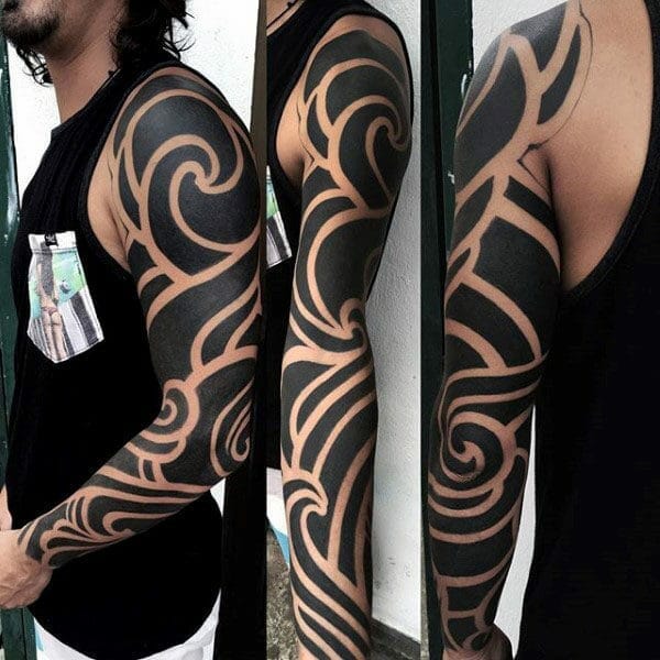 Blackwork Negative Space Full Sleeve Tribal Arm Tattoo