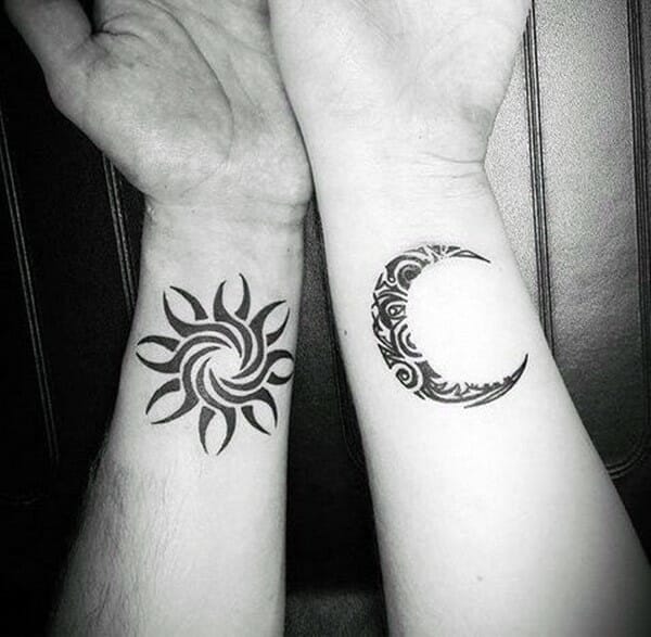 couples sun & moon tribal arm tattoos