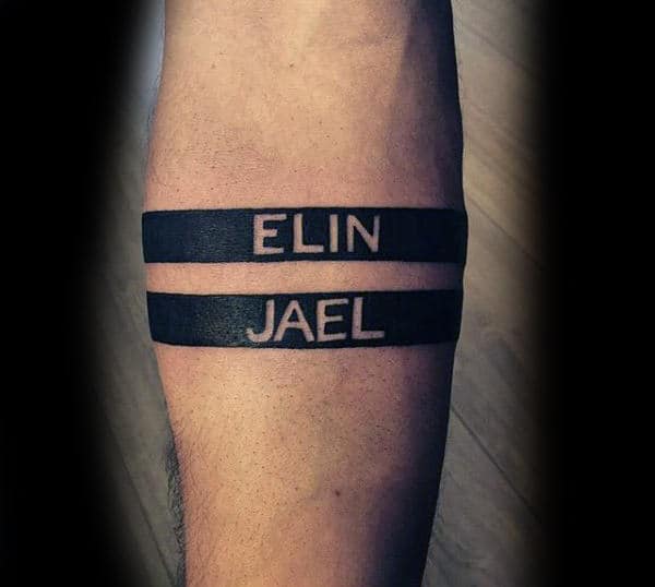 man with negative space black ink armband name tattoo Outsons