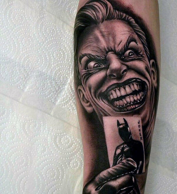 The Joker Holding a Playing Card with Batman on it Tattoo Sleeve