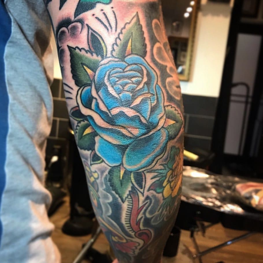 Traditional black blue rose tattoo Outsons