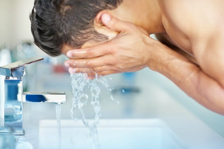 man washing face cleanse