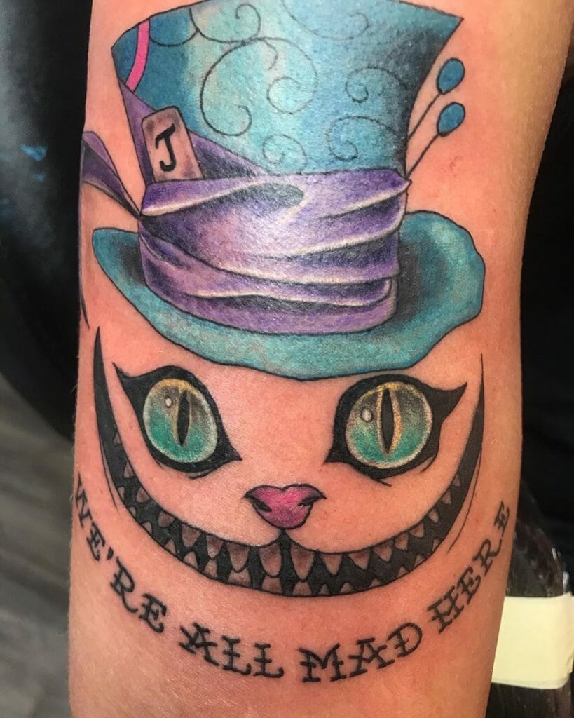 Blue And Purple Cheshire Cat Tattoo With A Phrase