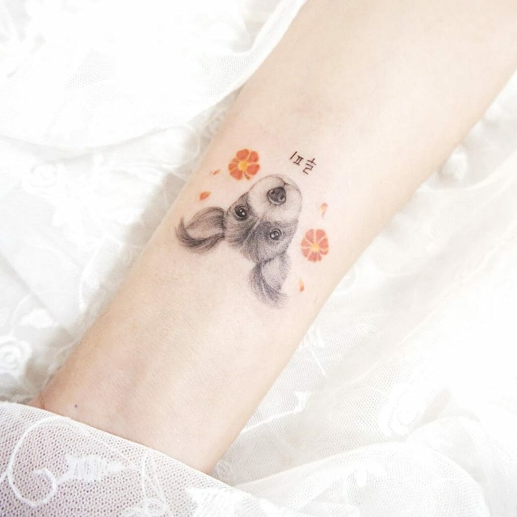 Small Puppy and Marigold Flower Tattoo