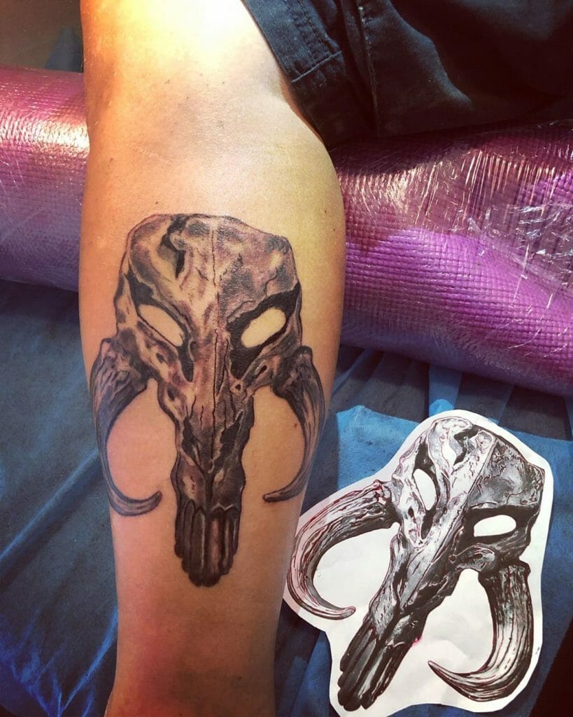 Black and Gray Mandalorian Symbol Skull Tattoo Design Leg Placement