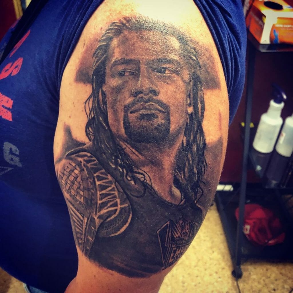 Black and Gray Roman Reigns Good Looking Face Tattoo Biceps Placement