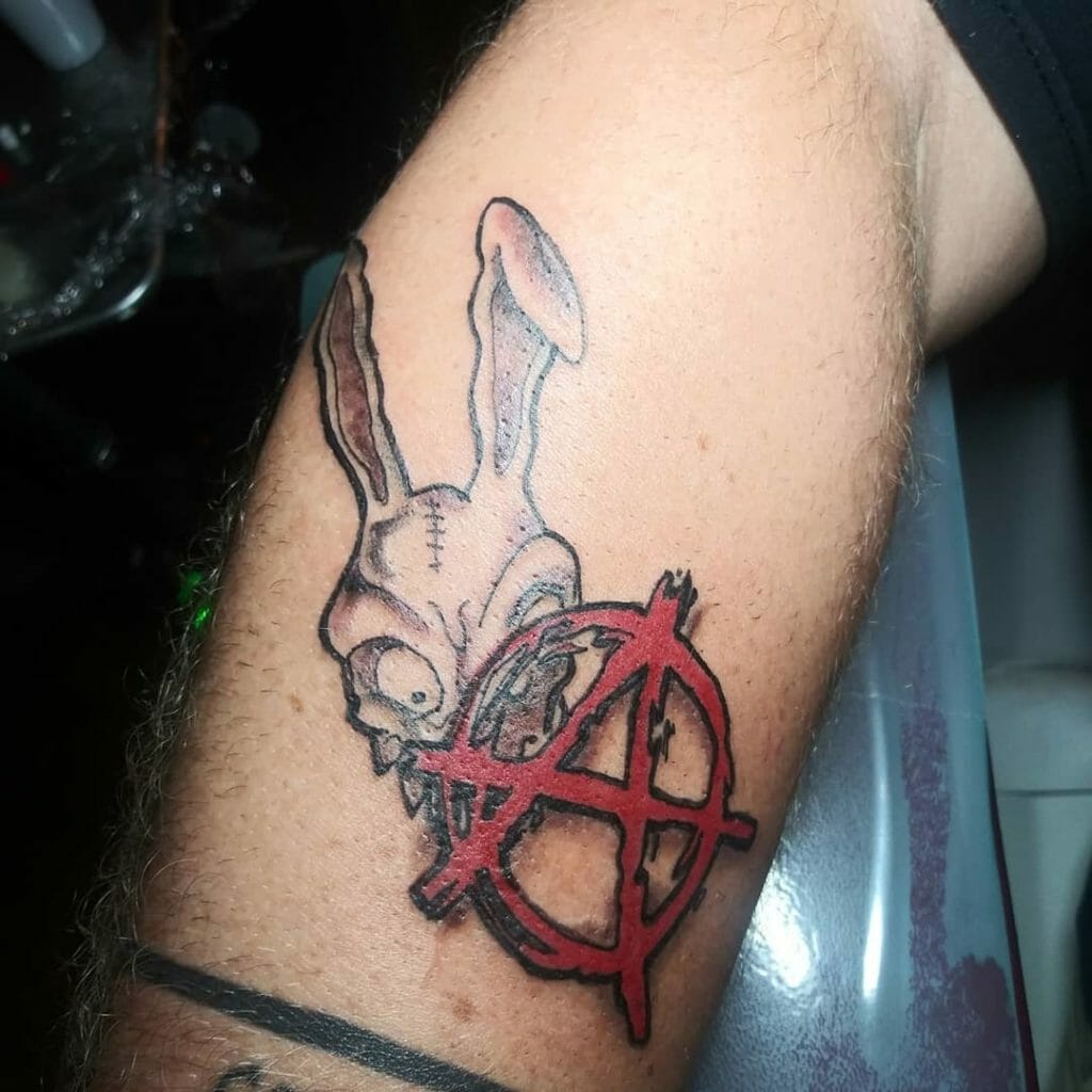 Creepy Bunny And Anarchy Symbol Tattoo In Red Ink Upper Arm Placement Tatto...