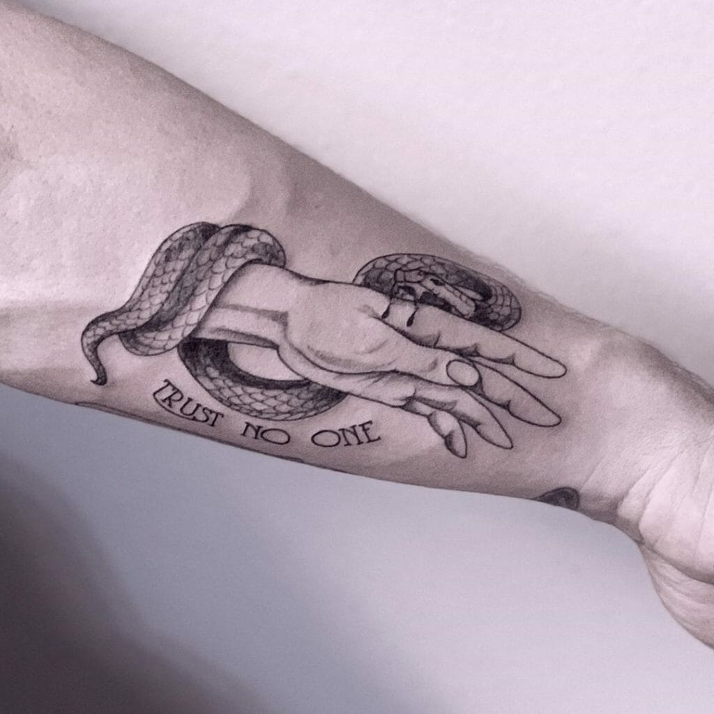 Snake Biting Reaching Hand Black Ink Tattoo