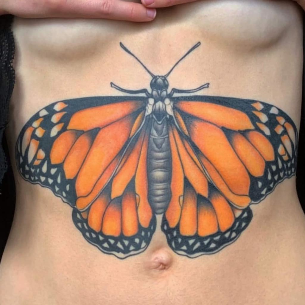 Dramatic And Colorful Monarch Butterfly Tattoo On Chest